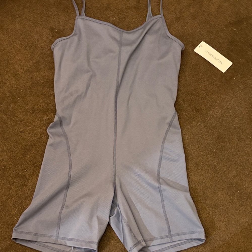 Yogalicious Lux White Logo Tag on Brown Background